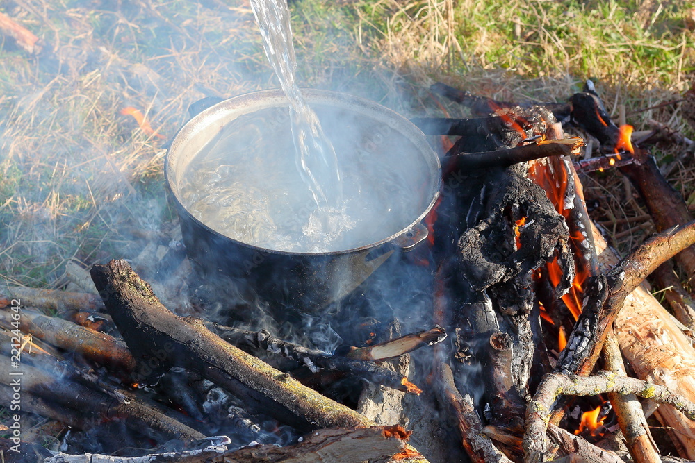 Cauldron on fire in forest. Cooking in the nature. Cauldron on fire in forest. Cooking in the nature.