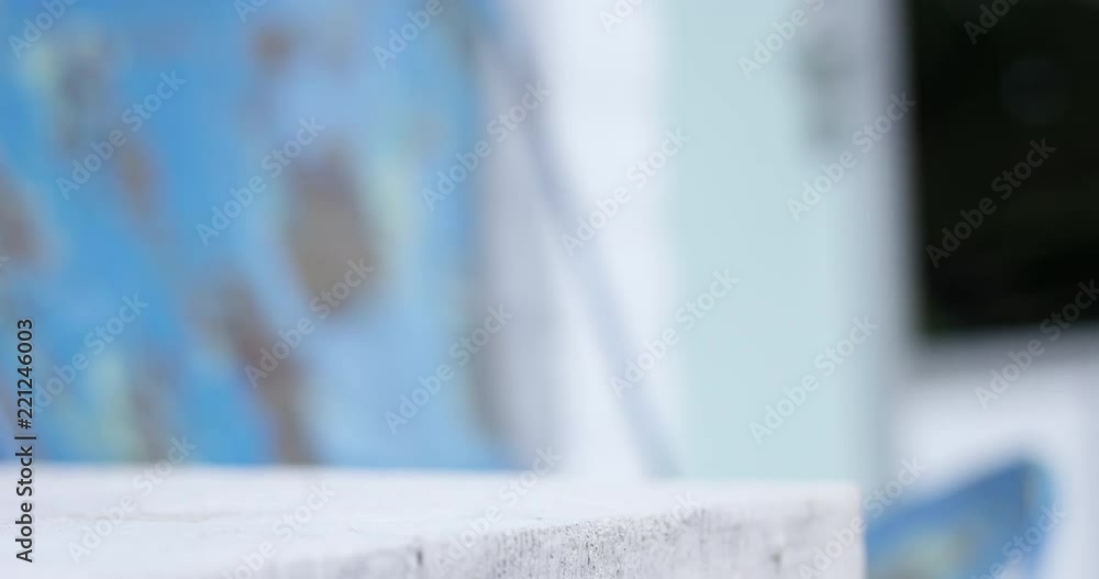 Womans hand picks up plain white to go coffee cup on table outdoors - copy space right Womans hand picks up plain white to go coffee cup on table outdoors - copy space right
