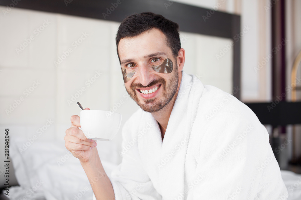 Handsome man drinking morning coffee in the bed Handsome man drinking morning coffee in the bed