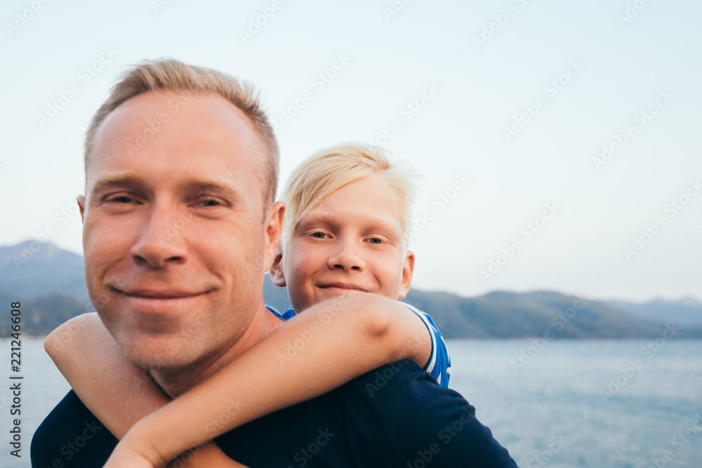 Father and son together. Son hugging father. Summer vacation.