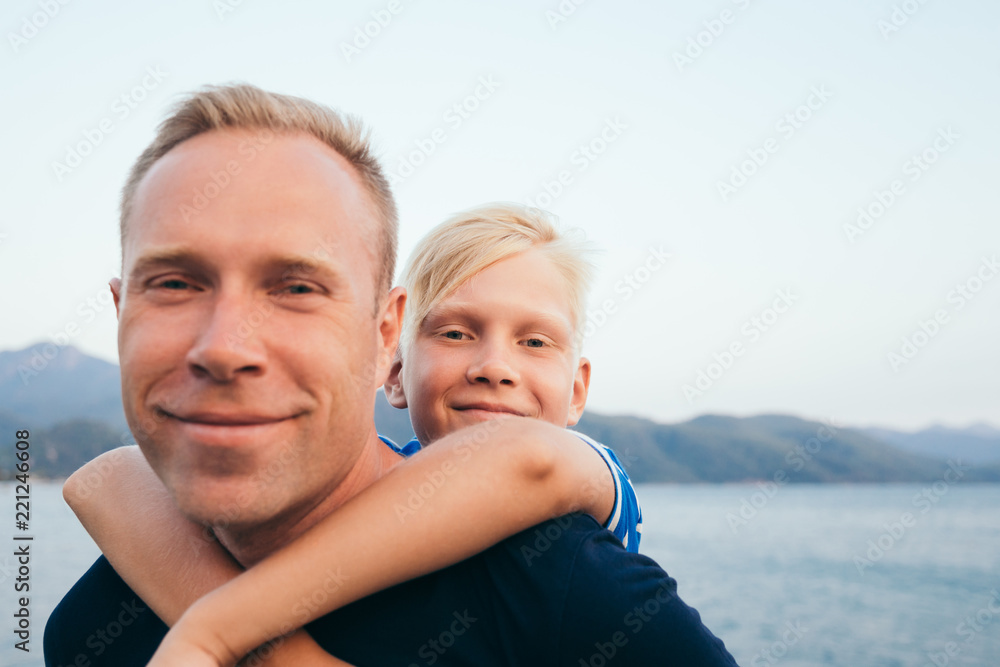 Father and son together. Son hugging father. Summer vacation. Father and son together. Son hugging father. Summer vacation.