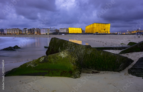 SAN SEBASTIAN, SPAIN - SEPTEMBER 5, 2018: Kursaal auditorium illuminated , international film festival, from the beach of Zurriola, San Sebastian photo