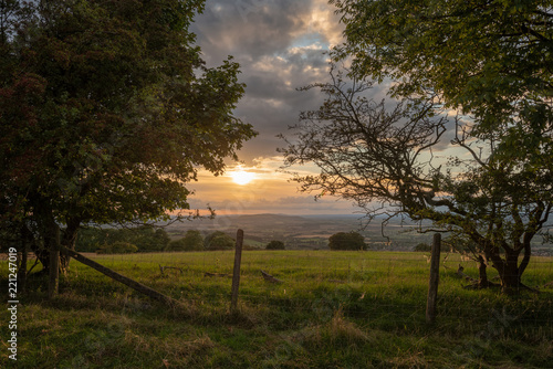 Beautiful dramatic Summer sunset landscape over English countryside with stunning light