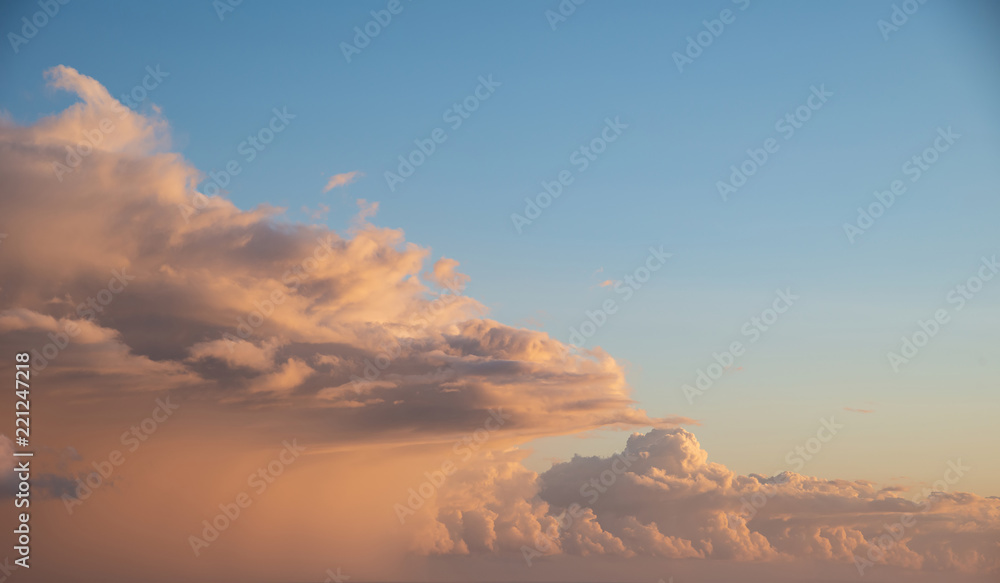 Beautiful cumulonimbus stormy rain cloud formations in Summer sunset sky with dramatic moody color and texture