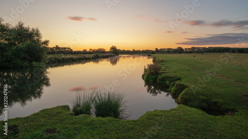 Beautiful dawn landscape image of River Thames at Lechlade-on-Thames in English Cotswolds countryside