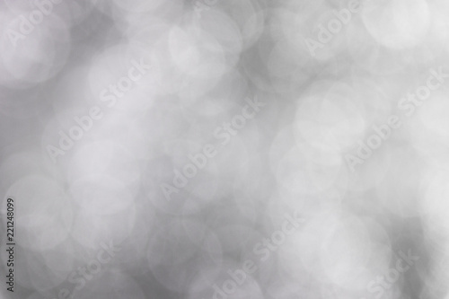 Abstract blurred white and grey bokeh background.