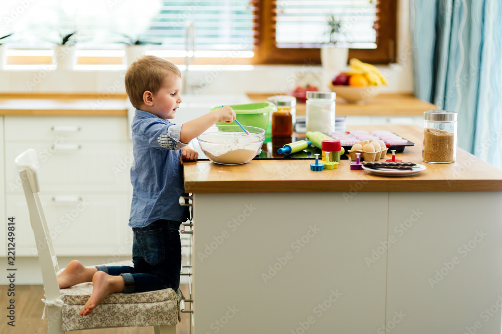 Toddler preparing food in kitchen Toddler preparing food in kitchen