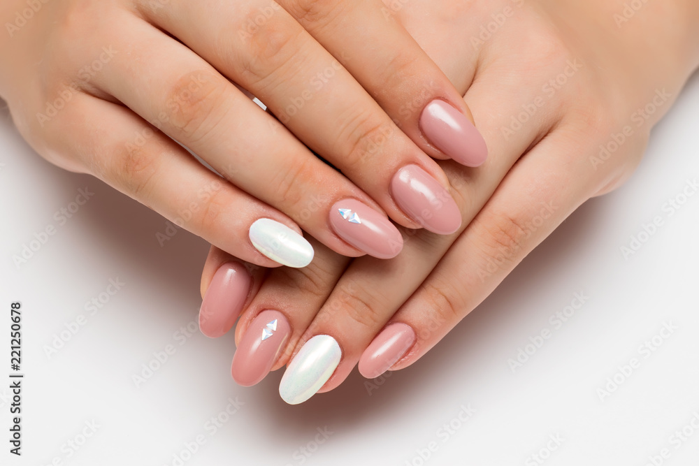 gently pink manicure with white pearly rub on long oval nails with crystals, rhombuses on a white background
gently pink manicure with white pearly rub on long oval nails with crystals, rhombuses on a white background
