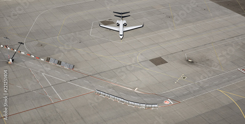 Aerial view private airplane parked on tarmac at airport photo