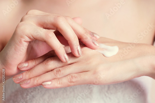 Woman applying moisturizing cream/lotion on hands, Tone image, beauty concept. © BoszyArtis