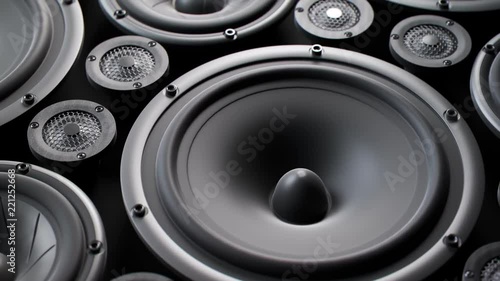 Vibrating speaker membranes stacked in endless loop. Lit by studio lights. 4k HD photo
