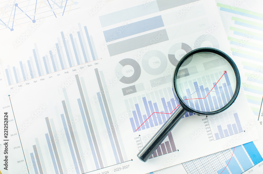 Magnifying glass with data Business Graphs finance Chart document. Magnifying glass with data Business Graphs finance Chart document.
