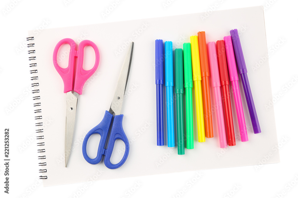 Set of colorful felt tip pens and two scissors on a blank, opened sketchbook sheet, isolated on white background. Art and creativity concept Set of colorful felt tip pens and two scissors on a blank, opened sketchbook sheet, isolated on white background. Art and creativity concept
