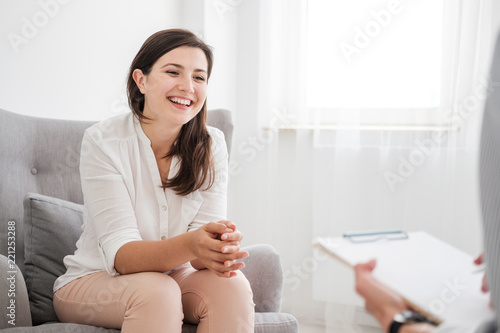 Happy young woman talking to a financial expert about a loan for a new apartment