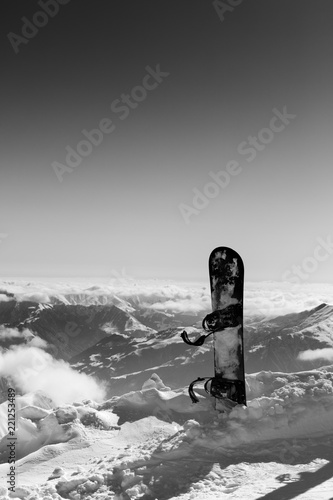 Black and white view on snowboard in snow on off-piste slope