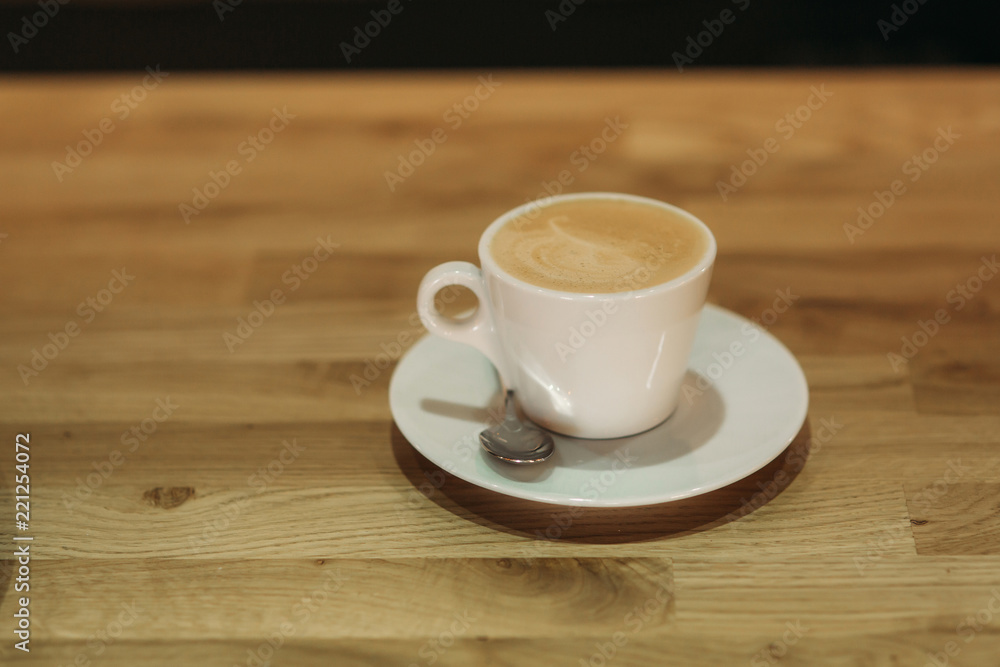 Beautiful cappuccino on a wooden background in cafe Beautiful cappuccino on a wooden background in cafe