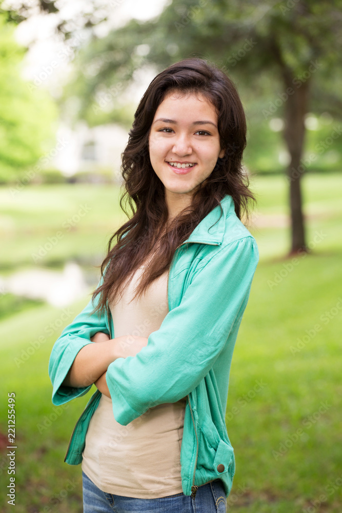 Young teen girl smiling outside. Young teen girl smiling outside.