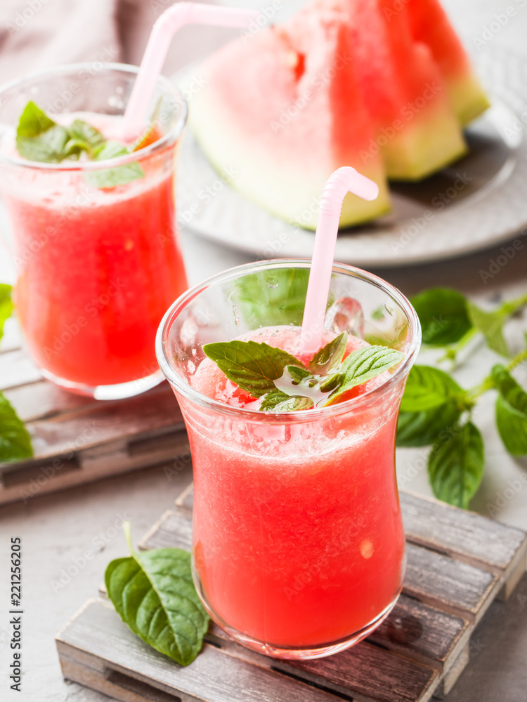 Fresh watermelon smoothie with ice and mint leaves in glasses. Fresh watermelon smoothie with ice and mint leaves in glasses.