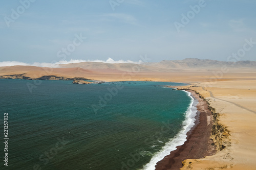 Fototapeta Naklejka Na Ścianę i Meble -  Natural reserve in Paracas, Peru. Blue sky, green sea, yellow cliffs, desert and ocean
