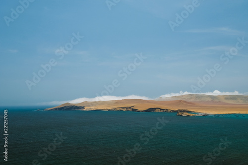 Natural reserve in Paracas, Peru. Blue sky, green sea, yellow cliffs, desert and ocean © Margarita Timofeeva
