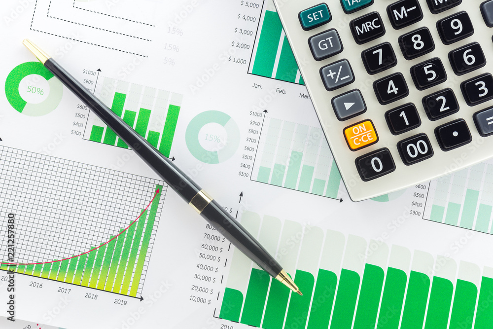 Calculator and Pen with Business Graphs finance document. Calculator and Pen with Business Graphs finance document.