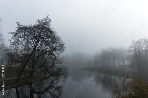 Dark Deventer City Park With Low Layer Of Fog
