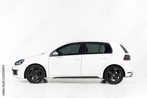 side view of one new white automobile on white © LIGHTFIELD STUDIOS