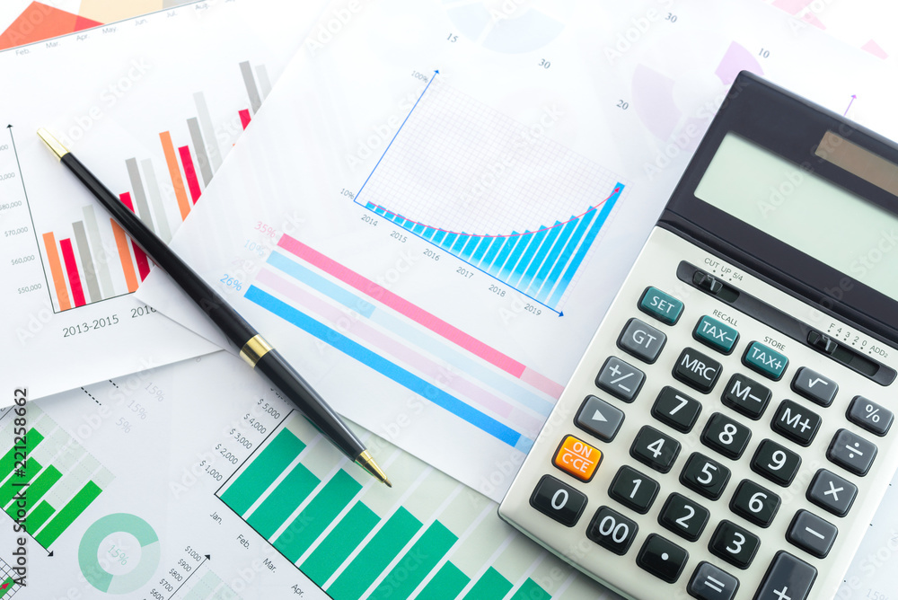 Calculator and Pen with Business Graphs finance document. Calculator and Pen with Business Graphs finance document.