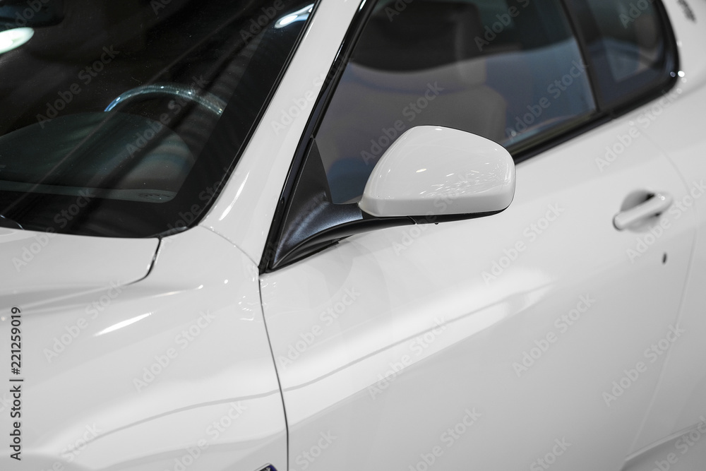 Veiw of a car sideways together with a mirror Veiw of a car sideways together with a mirror