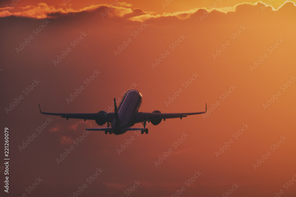 Aircraft taking off in the sunset