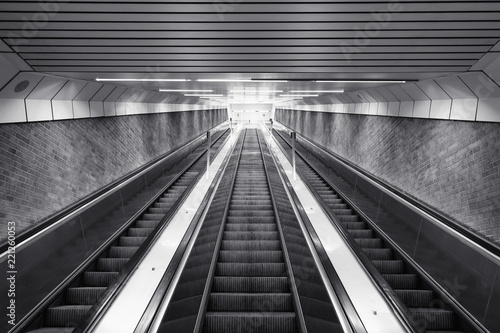 Black and white of ascending escalator