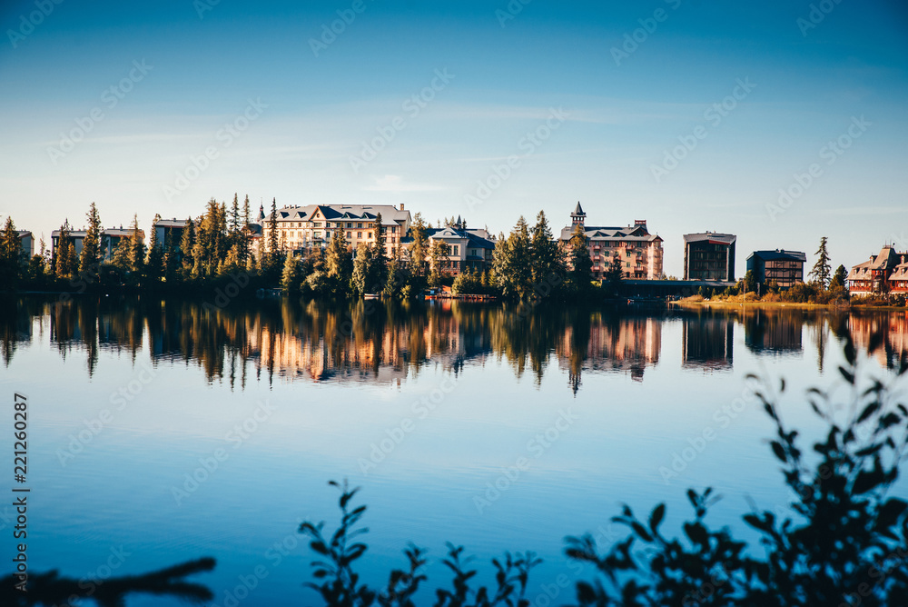 Naklejka premium Beautiful clear reflection of houses by lake. Strbske pleso, Slovakia
