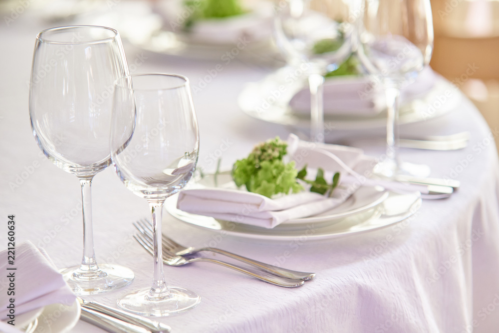 Empty clean wine glasses on served table in a restaurant