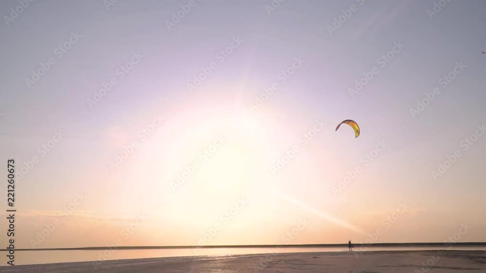 Beautiful dawn by the sea and the male kiter is slowly coming Beautiful dawn by the sea and the male kiter is slowly coming