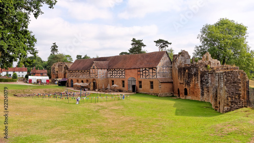 View of the ruins of Kenilworth Castle with a well-preserved stable on a sunny day,
