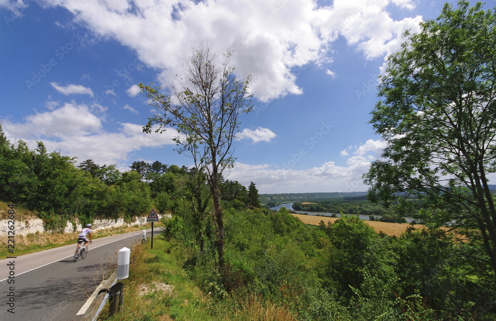 cyclist and country road in La Roche-Guyon hills