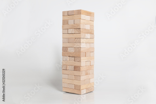 Wooden Block Tower in Shape on Gray Background. Selective Focus and Blank Space. © Hakan Kızıltan