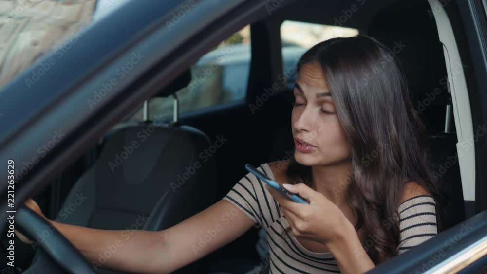 girl using smart phone voice recognition, dictates thoughts, voice dialing message speech ai helper at car driver inside student model young girl using smart phone voice recognition, dictates thoughts, voice dialing message speech ai helper at car driver inside student model young