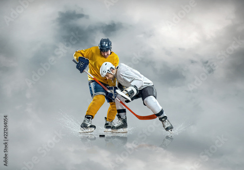 Ice hockey Players in dynamic action in a professional sport game play in hockey under stadium lights.