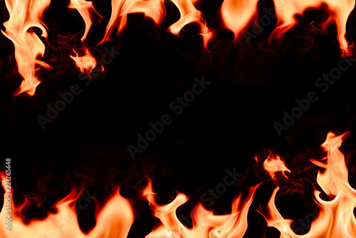 close up view of burning orange flame with blank space in middle on black background