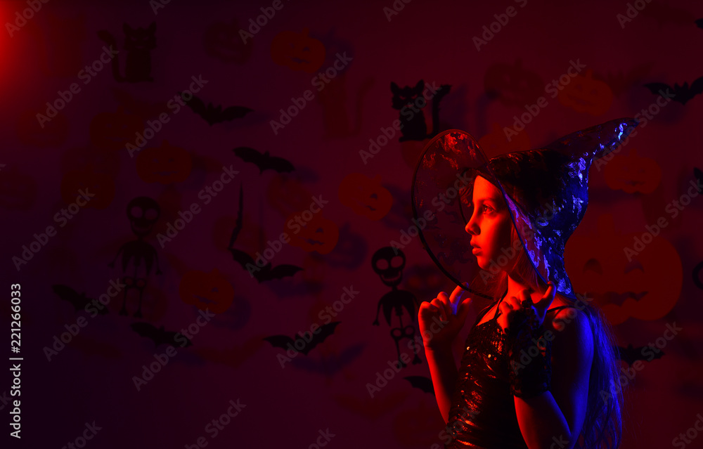 Beautiful girl witch on dark red background