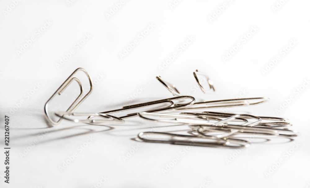 Metal clips jumping to music on a white background Metal clips jumping to music on a white background