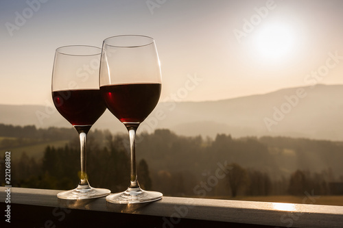 Two wine glasses at sunset time.