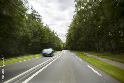 Motion Blur With Car Passing On Country Road