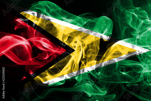 Valokuva National flag of Guyana made from colored smoke isolated on black background