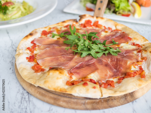 Traditional Italian fresh Prosciutto parma ham pizza.