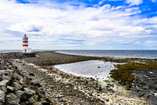 Beautiful Icelandic lighthouse against Atlantic Ocean. photo