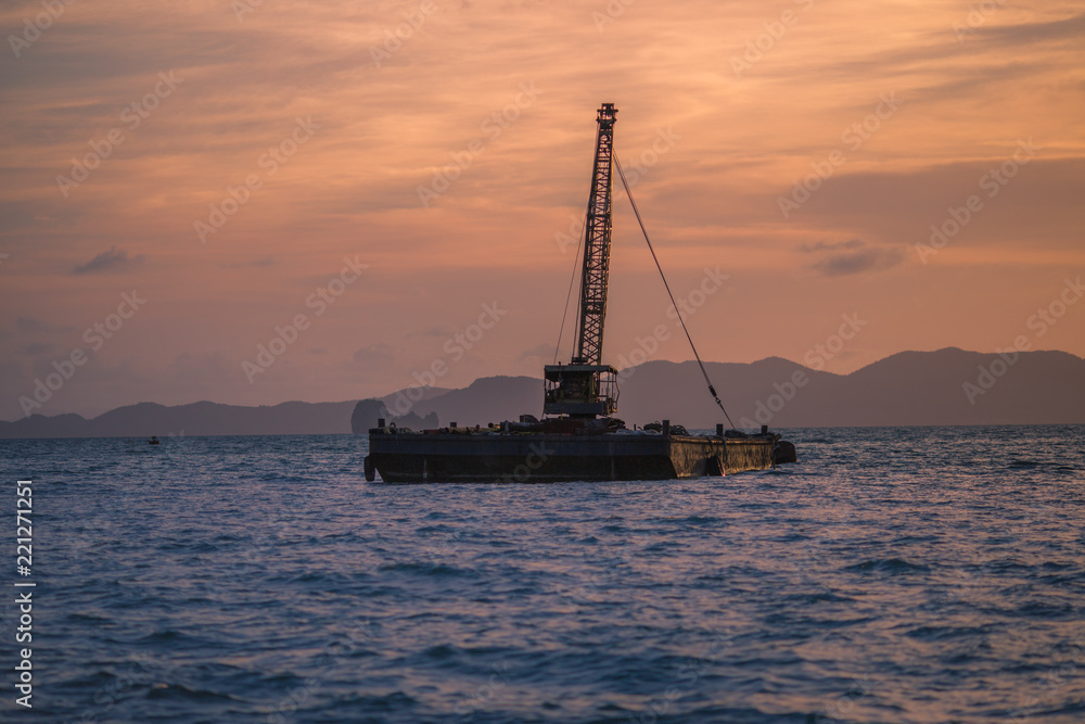 Background, silhouette of the seaside building, the back of a beautiful evening light, colorful color change, mining (mining in the sea)