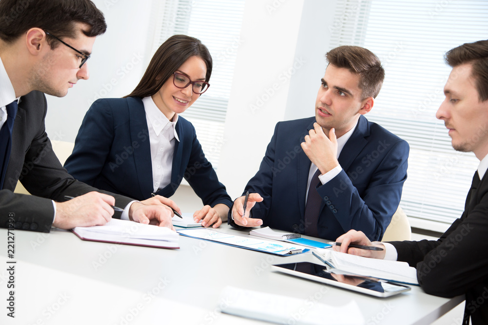 Businessman explains to colleagues a new project Businessman explains to colleagues a new project