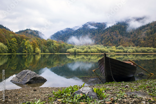 Wooden boat by mountain lake